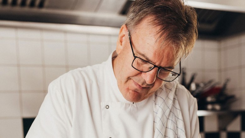 Heinrich Ellinger, © Niederösterreich Werbung/Daniela Führer Egy fehér egyenruhás szakács a munkájára koncentrál a konyhában.