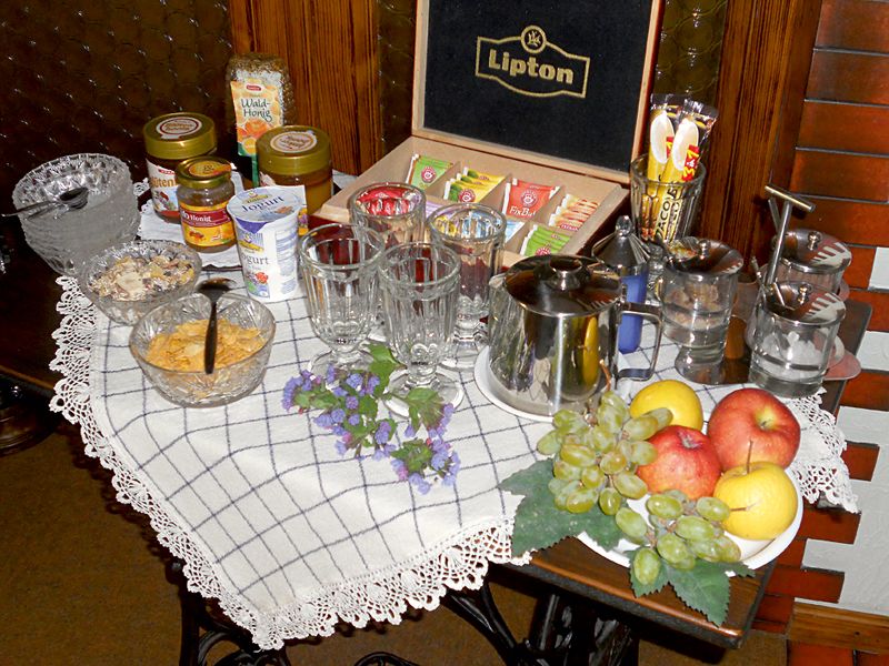 Svédasztalos reggeli különböző teákkal, gyümölcsökkel és kenhető ételekkel.