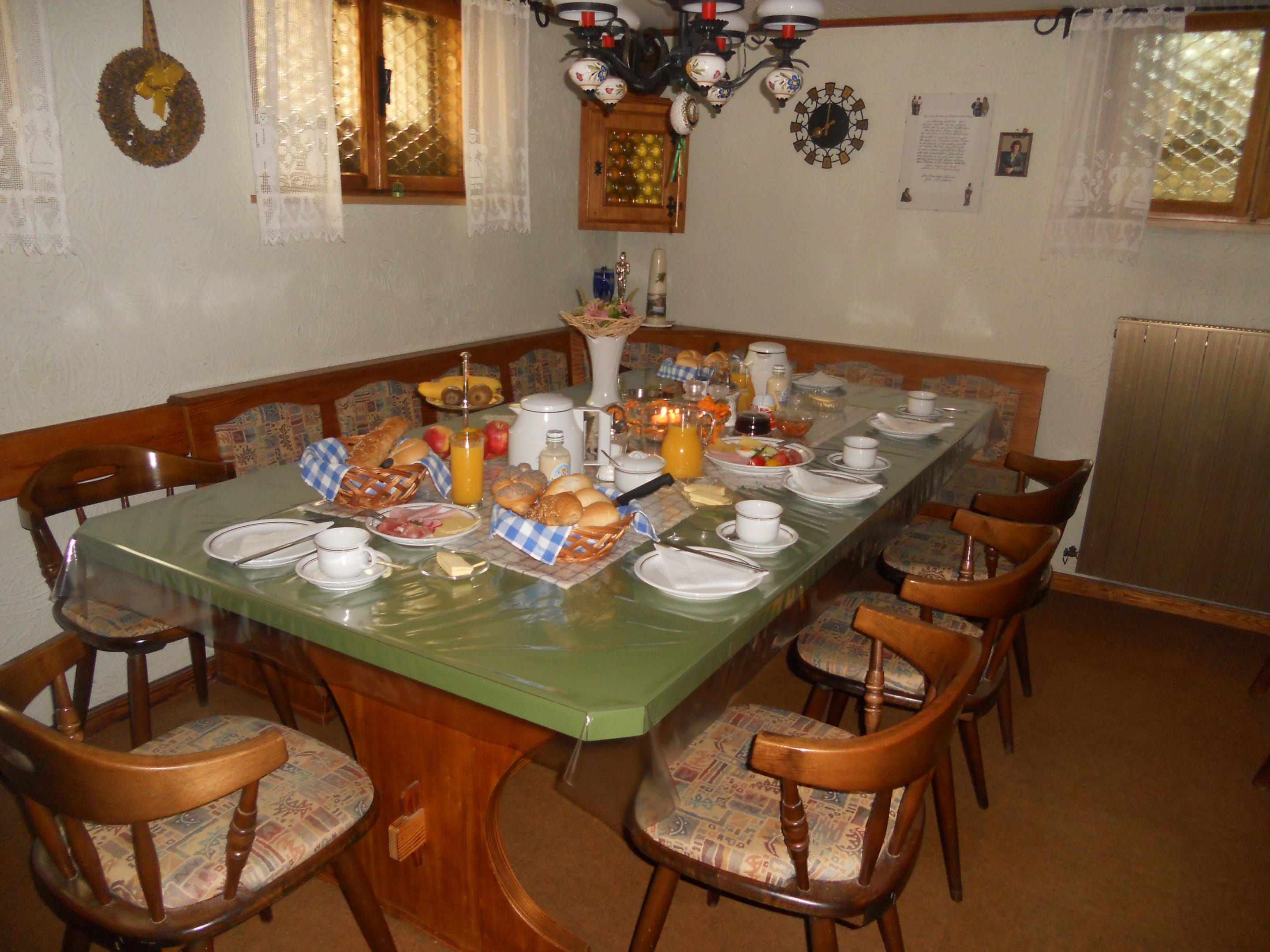 Reggelizőszoba asztallal és székekkel. Az asztalnál bőséges reggeli kerül terítékre.