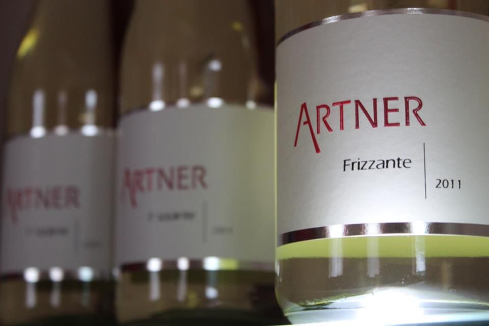 Közelkép az "Artner Frizzante 2011" feliratú borosüvegekről.