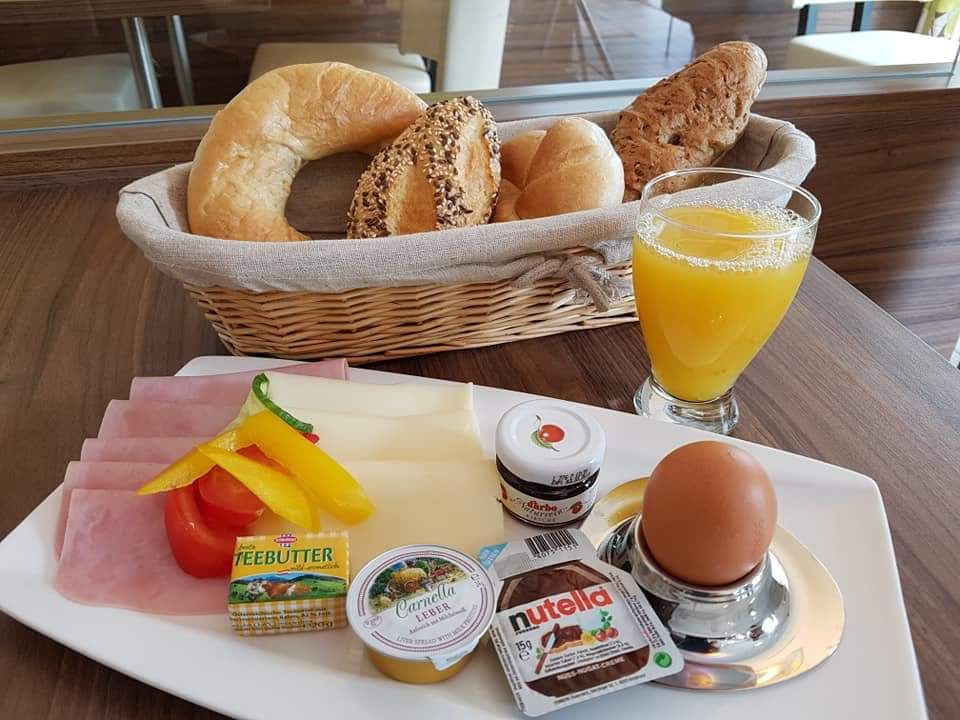 Reggeli tál zsemlével, felvágottal, tojással és narancslével.