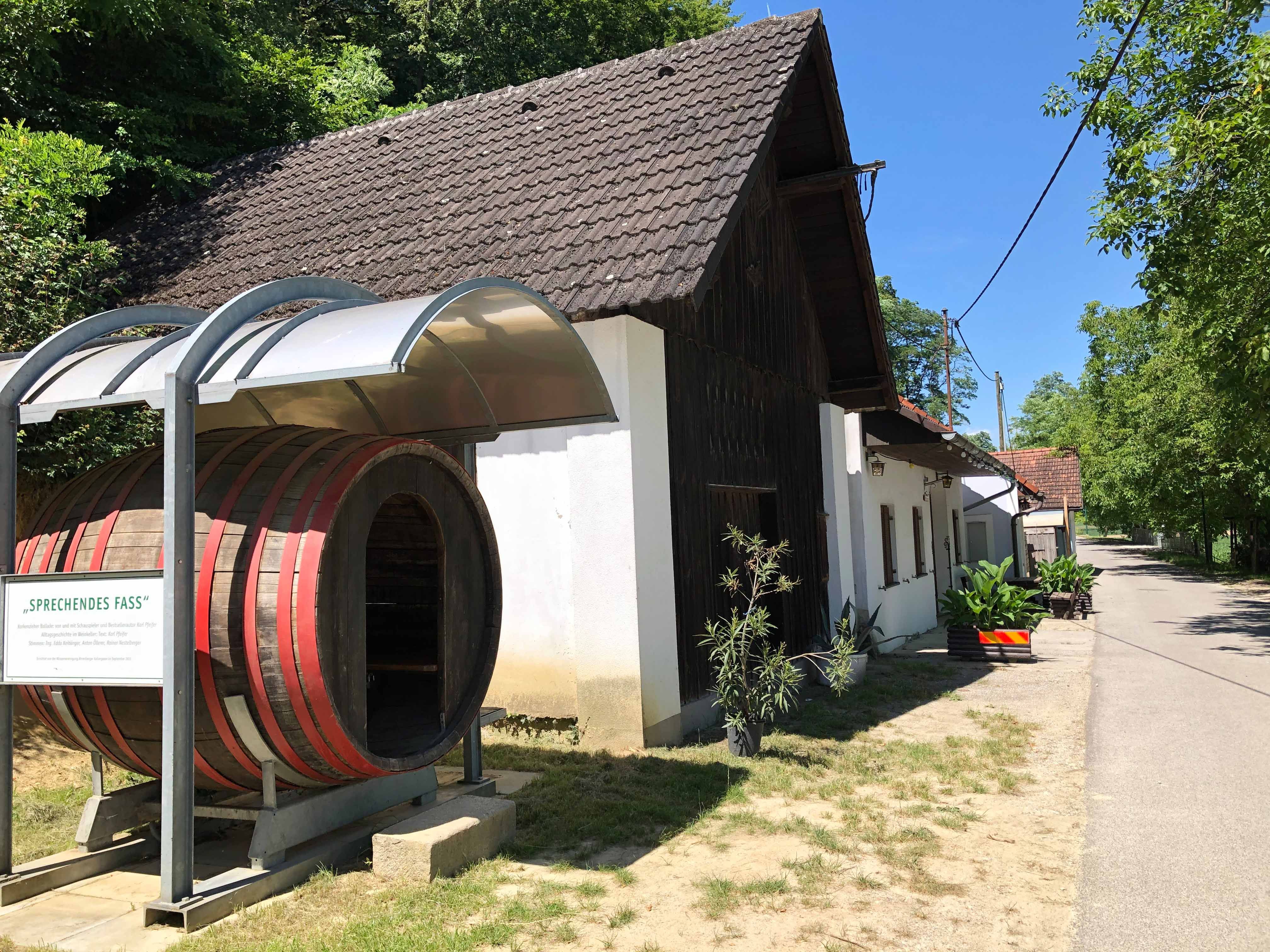 Borozó nagy hordóval és fedett bejárattal.
