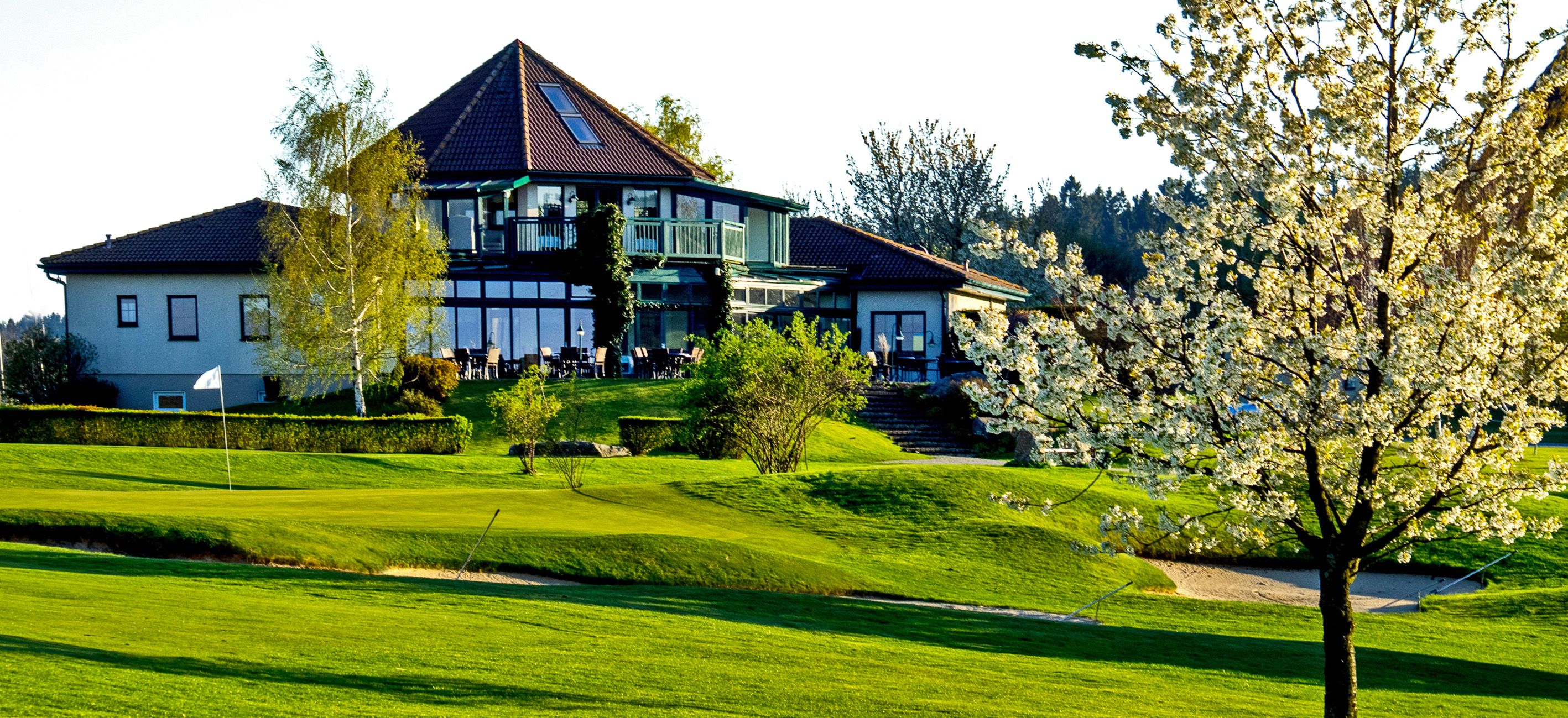 Az Ottenstein Golf Club klubháza, előtérben egy virágzó fa.