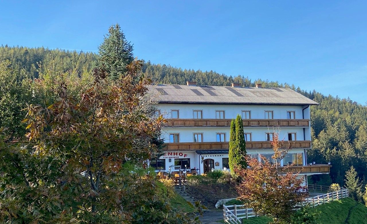 Gasthof-Pension Ödenhof egy erdős domb előtt.