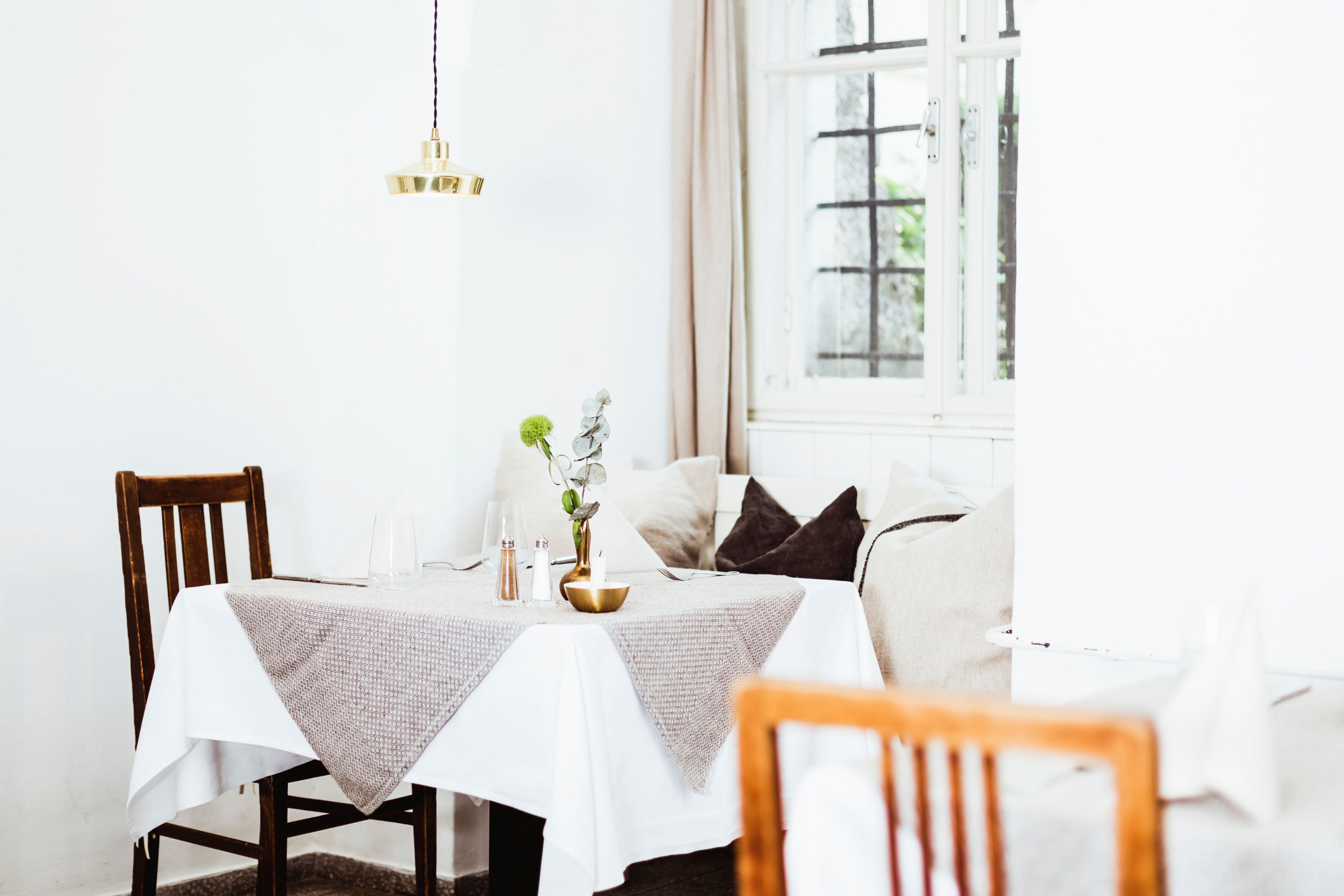 Hangulatos étterem fából készült bútorokkal és asztali díszítésekkel.