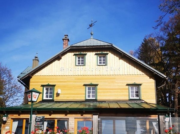 Fakunyhó, zöld redőnyökkel és időjárás-szabályozóval a tetőn.