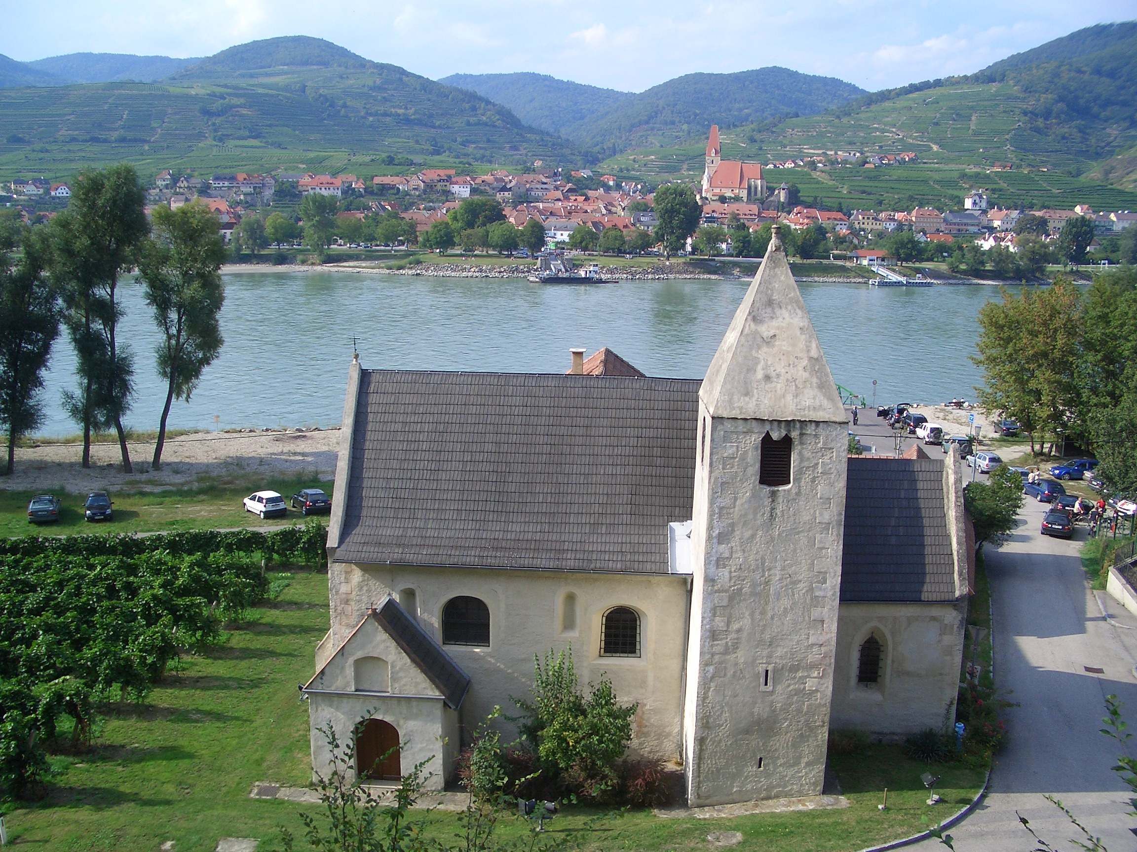 Szent Lőrinc templom, háttérben a folyó és a falu.