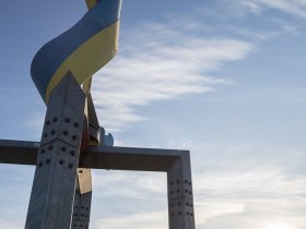 Egy nagy, dug&oacute;h&uacute;z&oacute; alak&uacute; szobor a k&eacute;k &eacute;gbolt &eacute;s a naplemente előtt.