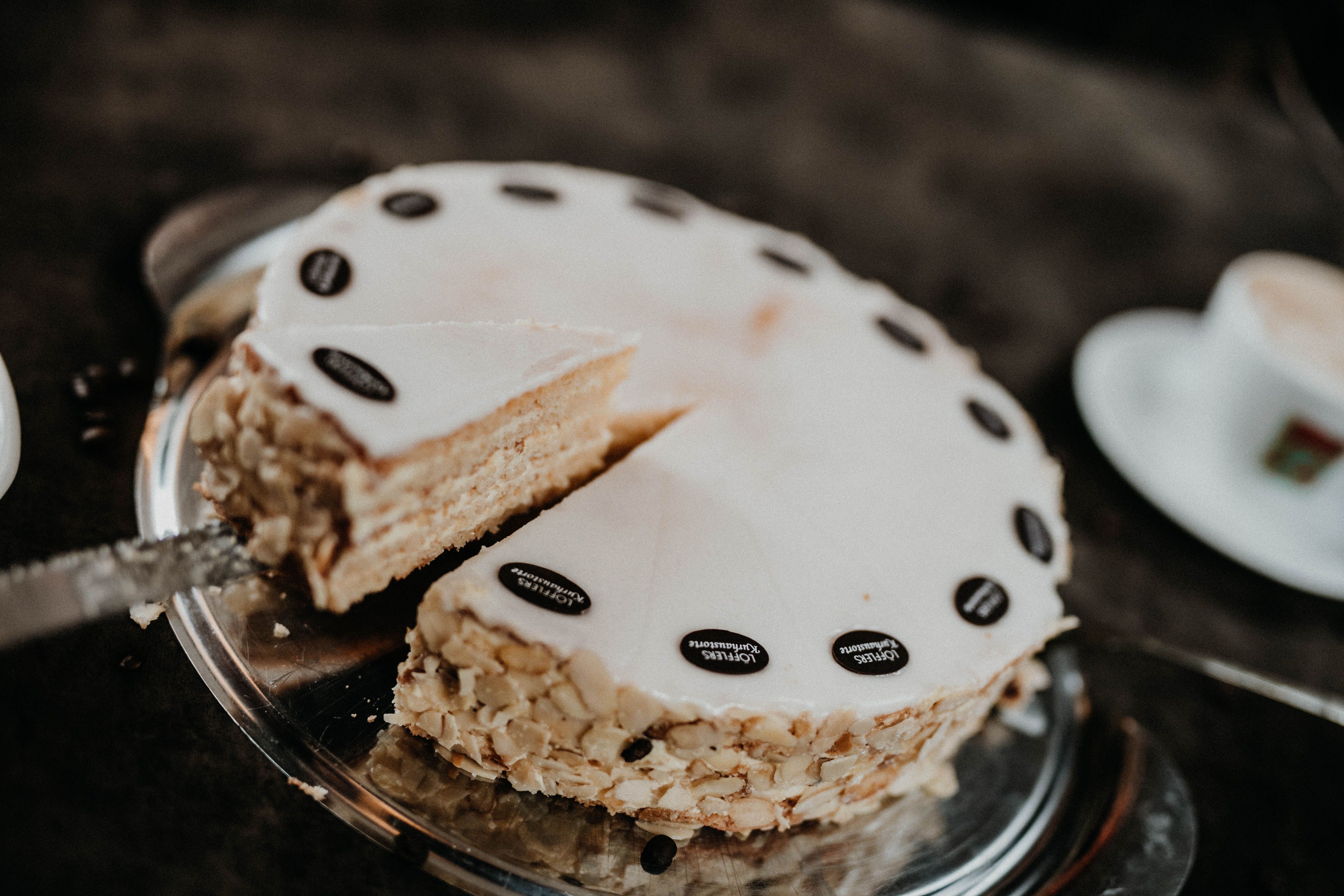 Egy tálcán levágott torta mandulával és csokoládéval díszítve.