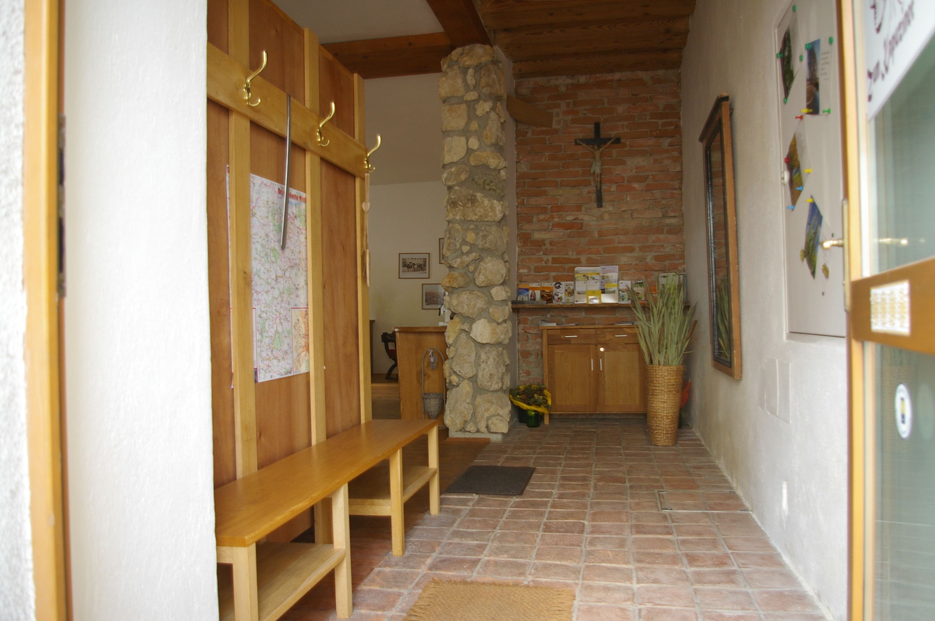 Bejárati rész fapadokkal, kőfallal és kereszttel.