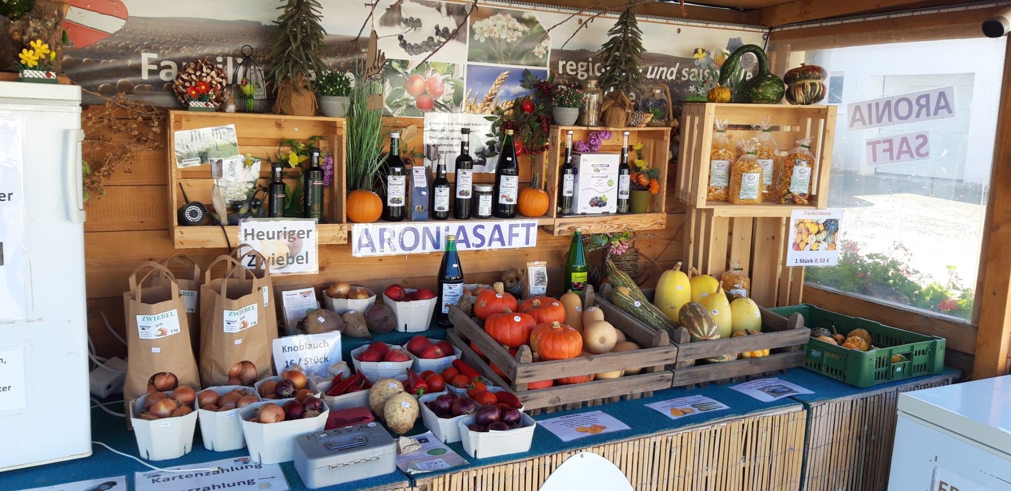 Regionális termékeket, például sütőtököt, hagymát és arónia levét árusító stand.