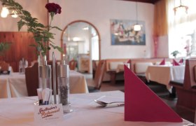 Restaurant Wirtshaus inside, set table with flower, © Gasthubers Wirtshaus